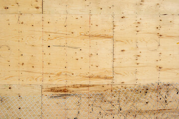 background: fresh plywood wall with chain link fencing  bottom of frame texture grtain and knots