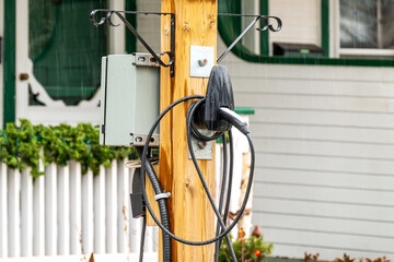 ev charging station in the front of a private home in an older residential neighbourhood shot in...