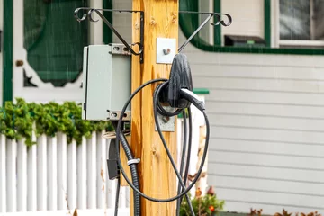 Tuinposter ev charging station in the front of a private home in an older residential neighbourhood shot in the toronto beaches © Michael Connor Photo