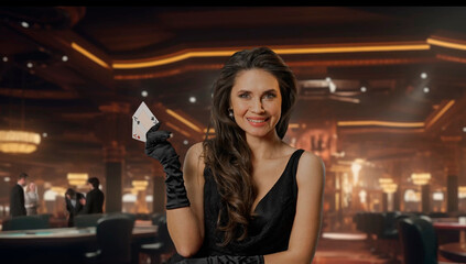 Chic woman in black dress at poker table for blackjack game in casino. The woman shows two aces on camera and smiles victoriously at her winnings. The concept of casino and gambling.