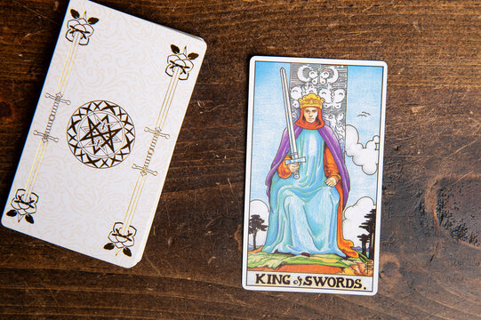 London, UK: 4 January, 2024: Minor Arcana - King of Swords of Tarot Card of Rider Waite deck on wooden background