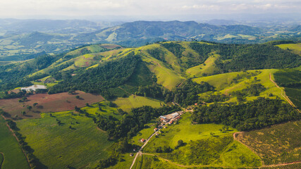 panoramic view of a rural village in the mountains of Minas Gerais with a range of mountains in the...