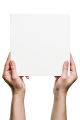 A person holding up a white piece of paper. Can be used for various purposes