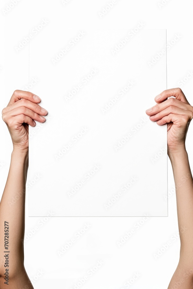 Poster A person holding up a white sheet of paper. Can be used for presentations or as a blank canvas for creative projects