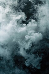 Fototapeta premium A black and white photo capturing smoke in the air. Can be used to depict mystery, pollution, or a dramatic atmosphere.