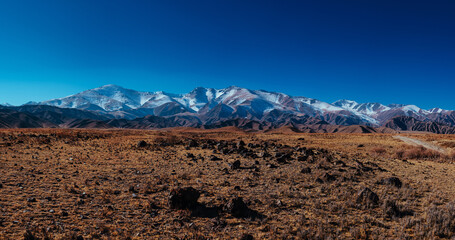 Picturesque panorama with snowy high mountains in autumn