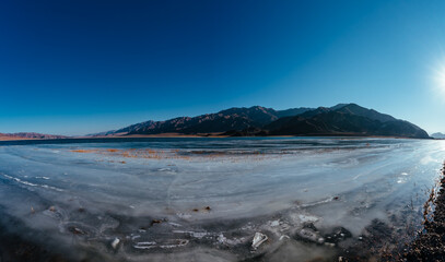 Wide angle panorama of frozen lake in winter