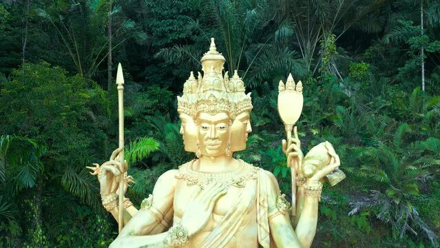 Aerial view on Gold Brahma God Statue on Jungle Desa Duda in Bali. Discover the Rich Hinduism Heritage of Asia's Vacation Destination in Indonesia.