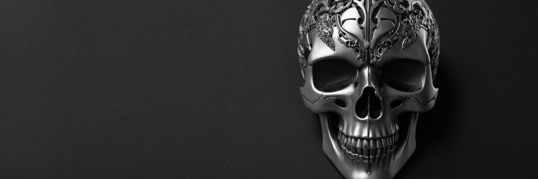 Silver skull with a crown on a black background