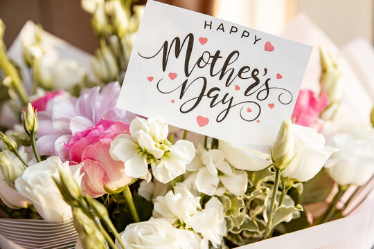 beautiful mixed flowers into a vase. the work of the florist at a flower shop. luxury bouquet of flowers.White Freesia , Ranunculus asiaticus, eustoma flowers, roses and eucalyptus. Happy mothers day