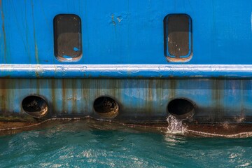an old boat is anchored in the water with holes going into it