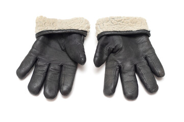 Old black leather warm gloves on a white background.