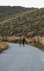 Obraz premium Two men jogging, running on a slope, Spain, Andalusia