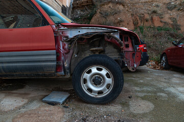 A broken down red car, side profile, wheel, tire, carosserie.