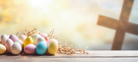 Easter eggs and cross on wooden table with bokeh background