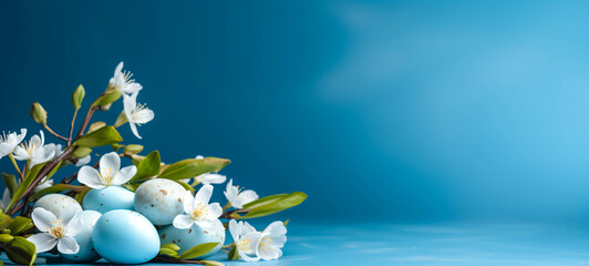 Easter eggs and spring flowers on a blue background. Banner.