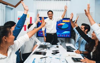 Analyst team leader celebrate with his colleague after successful data analysis meeting using...