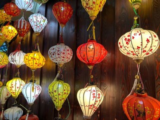 Fototapeta na wymiar hanging lanterns in chinese shop with wooden wall and ceiling, near to street