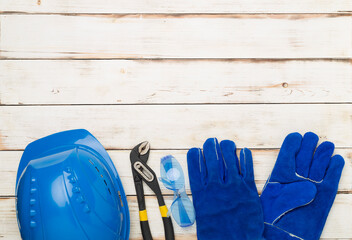 Blue construction equipment on wooden background, top view