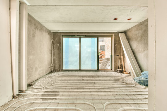 Unfinished room interior with underfloor heating installation