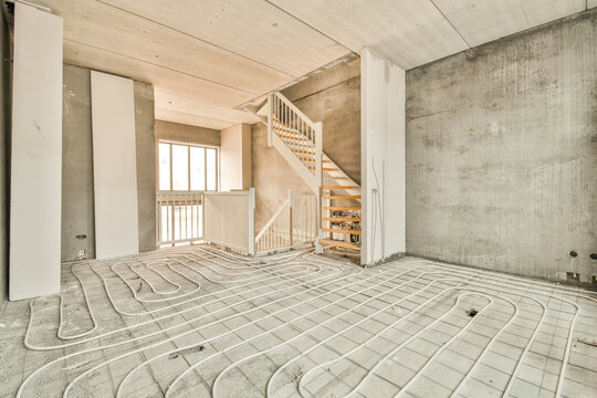 a living room with a staircase and a large floor