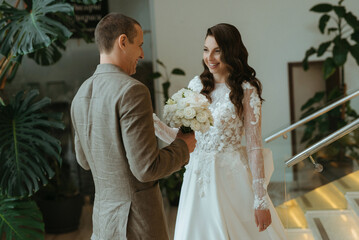Fototapeta premium meeting of the bride and groom on the hotel stairs