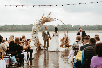 wedding ceremony of the newlyweds on the pier