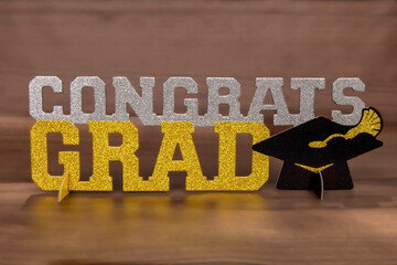 A decorative glitter congrats grad sign
