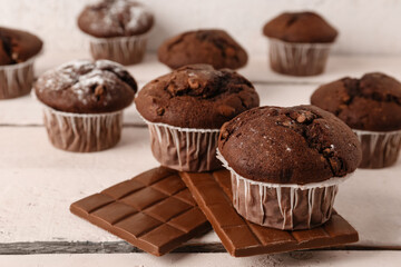 Tasty chocolate cupcakes on table