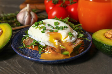 Plate with tasty egg Benedict on table
