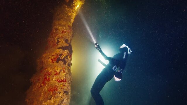Cave freediving. Freediver swims underwater and explores intricate labyrinths of the cave in the West Papua, Indonesia