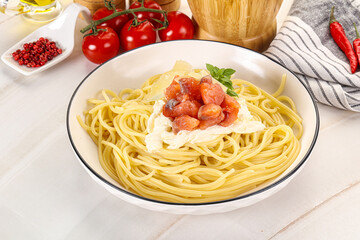 Pasta spaghetti with salmon and stracciatella