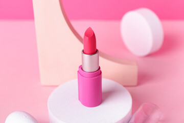 Decorative plaster podiums and lipstick on pink background
