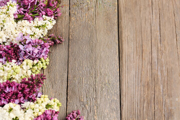 Lilac twigs on wooden background