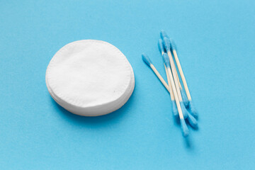 Cotton swabs buds and cotton pads on a white background.