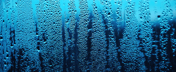 Texture of misted glass in autumn. Drops of water on window in rainy weather.