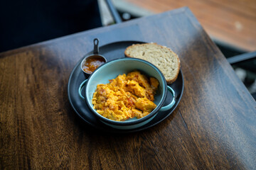 delightful breakfast platter of scrambled eggs with toast and natural peach jelly at colombian restaurant