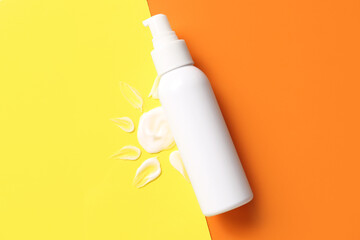 Drawing of sun made with sunscreen cream on color background