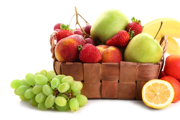 Wicker basket with different fresh fruits on white background