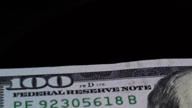 Extreme closeup of security seal on The US Dollar bill's security feature, while it is rotating on an automatic table.