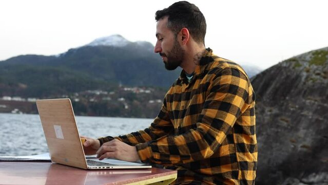 entrepreneurial businessman works from anywhere in the world - freelancer talking on the phone while teleworking