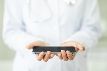Cropped of woman doctor hands holding cell phone