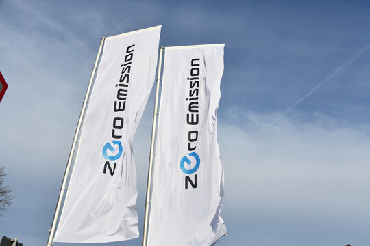 Celle, Lower Saxony, Germany - April 10, 2023: Zero emission flags on the site of a Nissan car dealer in Celle, Germany - Nissan is a Japanese multinational automaker