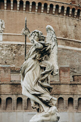 Fototapeta premium St. Angelo Bridge and Castel Sant'Angelo in Rome on a cloudy December day