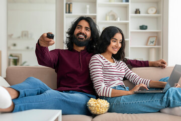 Loving young indian married couple relaxing at home