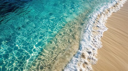 Obraz premium an aerial view of a beach with clear blue water and a wave coming in to the shore and a boat in the water at the shore line of the beach.