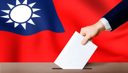 Taiwan presidential election. Hand holding ballot in ballot box with Taiwan flag in background