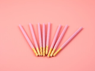 Crispy sticks in pink sugar glaze. Sticks in berry pink glaze on a pink background.