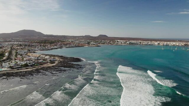 The drone aerial view of Corralejo. Corralejo is a town and resort located on the northern tip of Fuerteventura, one of the Canary Islands, facing the smaller islet of Lobos.