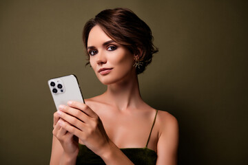 Photo of attractive stunning girl blogger chatting on smart phone device over green color background